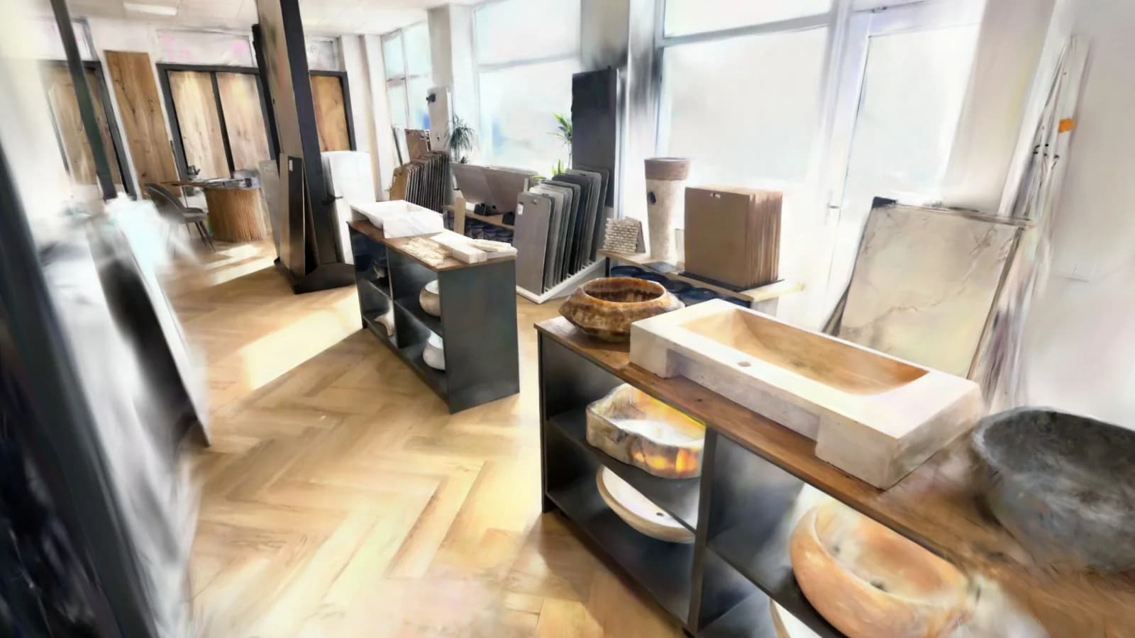 Blick in den Showroom: Waschtische mit Becken aus Naturstein und Onyx, dahinter Musterständer und Fenster